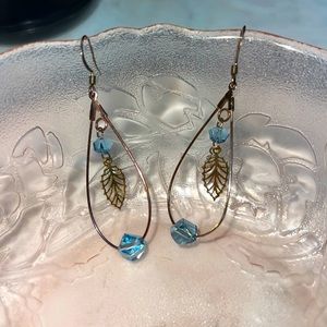 Dangle leaf blue crystal hoop earrings. Iridescent metal.  Cleaned and in EUC.